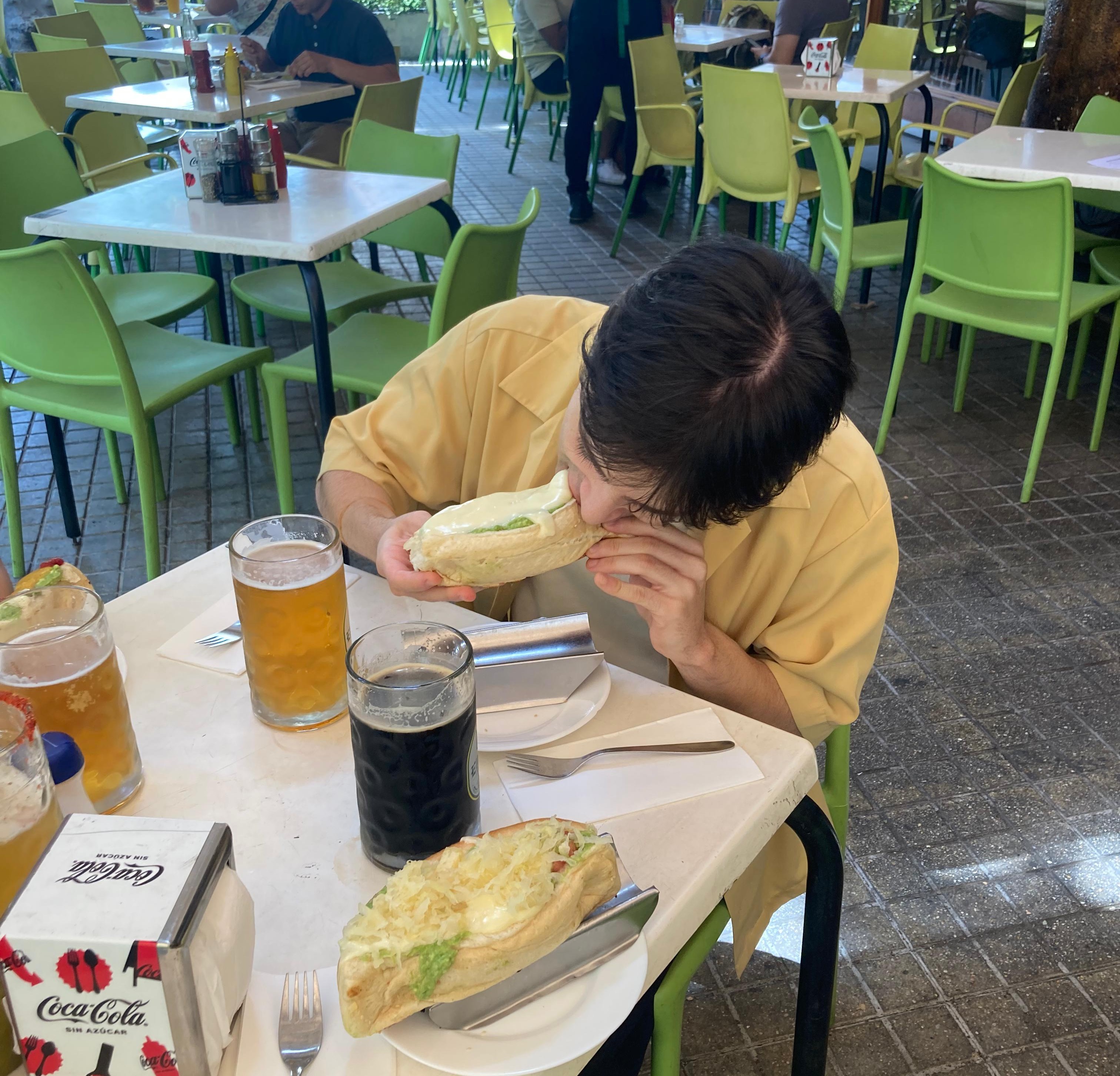 Nicolás Honorato-Droguett eating a completo in Chile